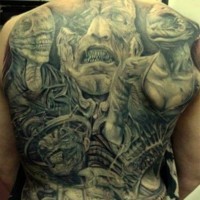 Big skull and demon and woman tattoo on chest and abdomen